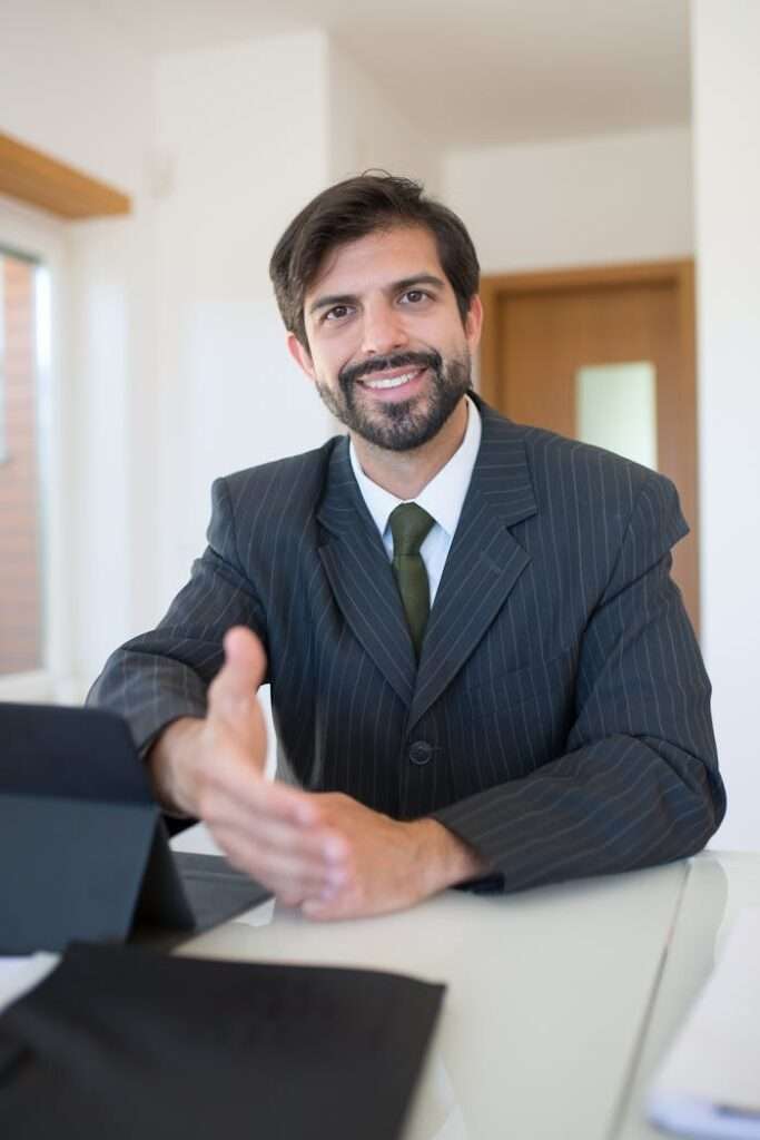 zipwp-image-8815878 Portrait of a Real Estate Agent Smiling in Blue Suit Jacket